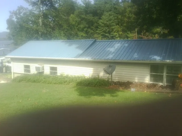 Blue metal roof running the length of a single story home in Saline